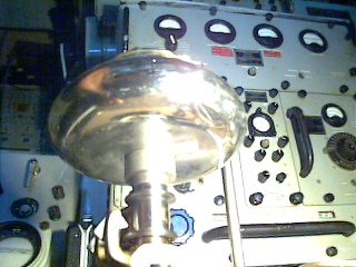 Close view of a laboratory control panel and shiny metal terminal